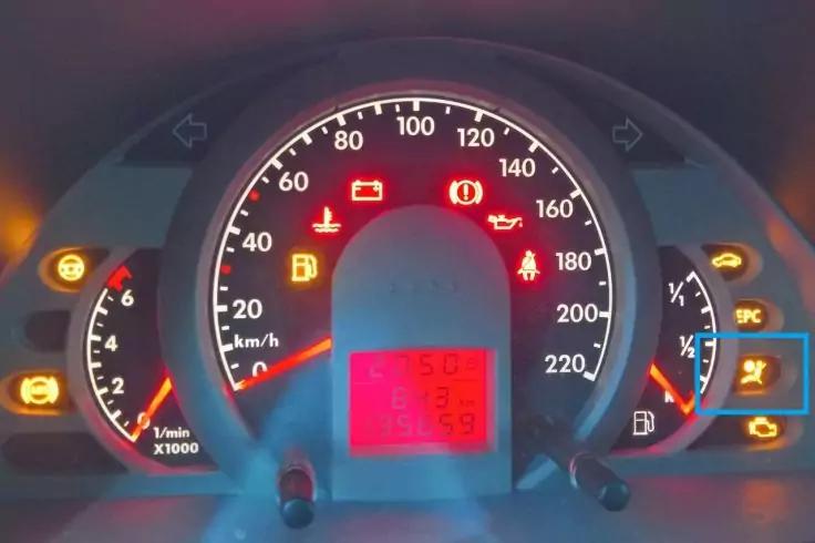 Fahrzeug-Instrumententafel mit rundem Tacho (0&ndash;220 km/h), Drehzahlmesser links, Kraftstoffanzeige rechts, rotem digitalen Display unten und mehreren roten und orangen Kontrollleuchten und Symbolen