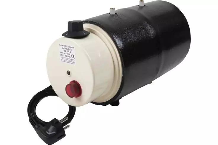 Zylindrischer schwarzer Korpus mit weißer Frontplatte, rotem runden Knopf, angeschlossenem schwarzem Kabel und Stecker; Aufkleber auf der Front, zwei Metallstifte oben, zwei kleine schwarze Füße