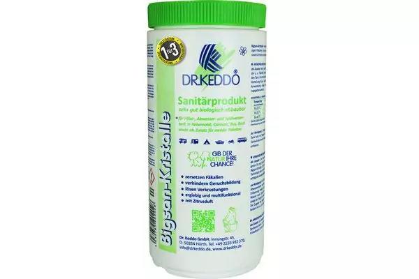 R&eacute;cipient en plastique blanc avec bouchon vert, face avant avec &eacute;tiquette vert-bleu, nom 'DRKEDDO' et petits pictogrammes