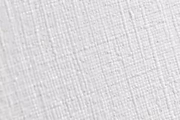 Nahe Aufnahme einer weißen, texturierten Fläche mit feinem, gleichmäßigem Kreuz-/Gittermuster