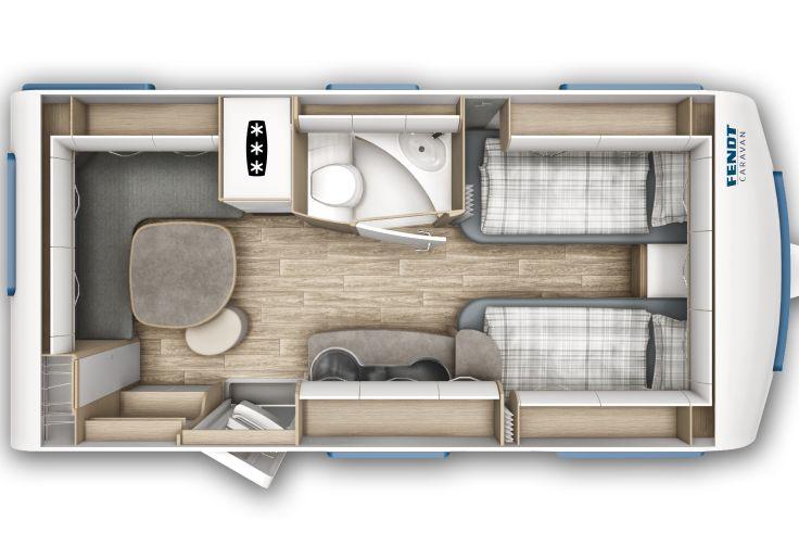 Vogelperspektive eines Wohnwagen-Grundrisses mit zwei Einzelbetten rechts, Badezimmer mit Toilette und Waschbecken oben in der Mitte, K&uuml;chenzeile mit Herd (drei Kochfelder) links vom Bad, Sitzgruppe mit Tisch unten links, Schr&auml;nke und Eingang unten,