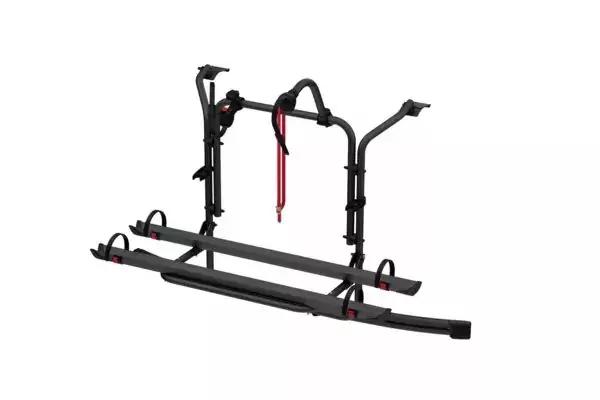 Schwarze Metallkonstruktion mit zwei parallelen Schienen, zwei aufrechten B&uuml;geln, gebogenen Haltearmen und roten Sicherungsb&auml;ndern vor wei&szlig;em Hintergrund