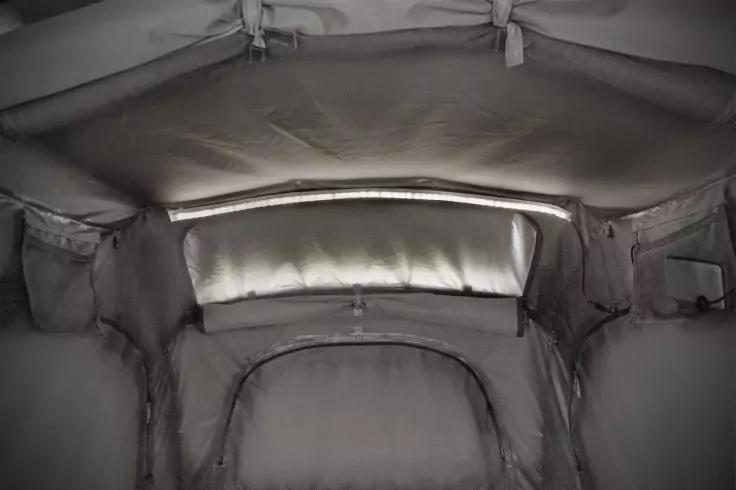 Innenraum mit stoffbezogenem, gewölbtem Dach, lichtdurchlässigem rechteckigem Einsatz, gepolsterter Bereich unten, sichtbare Nähte und Seitentaschen