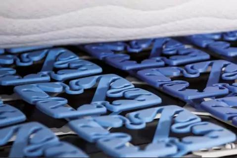 Blaue Kunststoffbuchstaben in Reihen auf schwarzen Tr&auml;gern, dar&uuml;ber eine wei&szlig;e gewellte Oberfl&auml;che