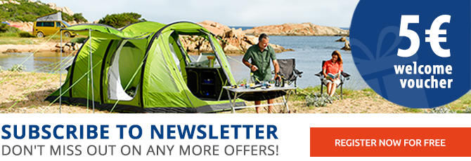 Group of people on a meadow with tents in the background