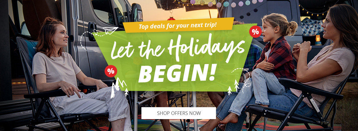 Desktop slider with reference to the vacation start with great offers. A group of people sitting at an outdoor table and chatting.
