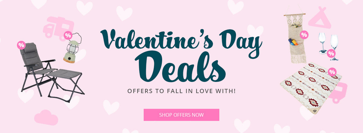 Pink background with heart motifs, centered large text 'Valentinstag Deals', below 'Angebote zum Verlieben' and a pink button 'Zu den Angeboten', surrounded by product images: folding lounge chair, blanket with heart pattern, candles, small figurines and caravan icons