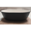 Black oval bowl with white interior on a wooden surface, blurred background