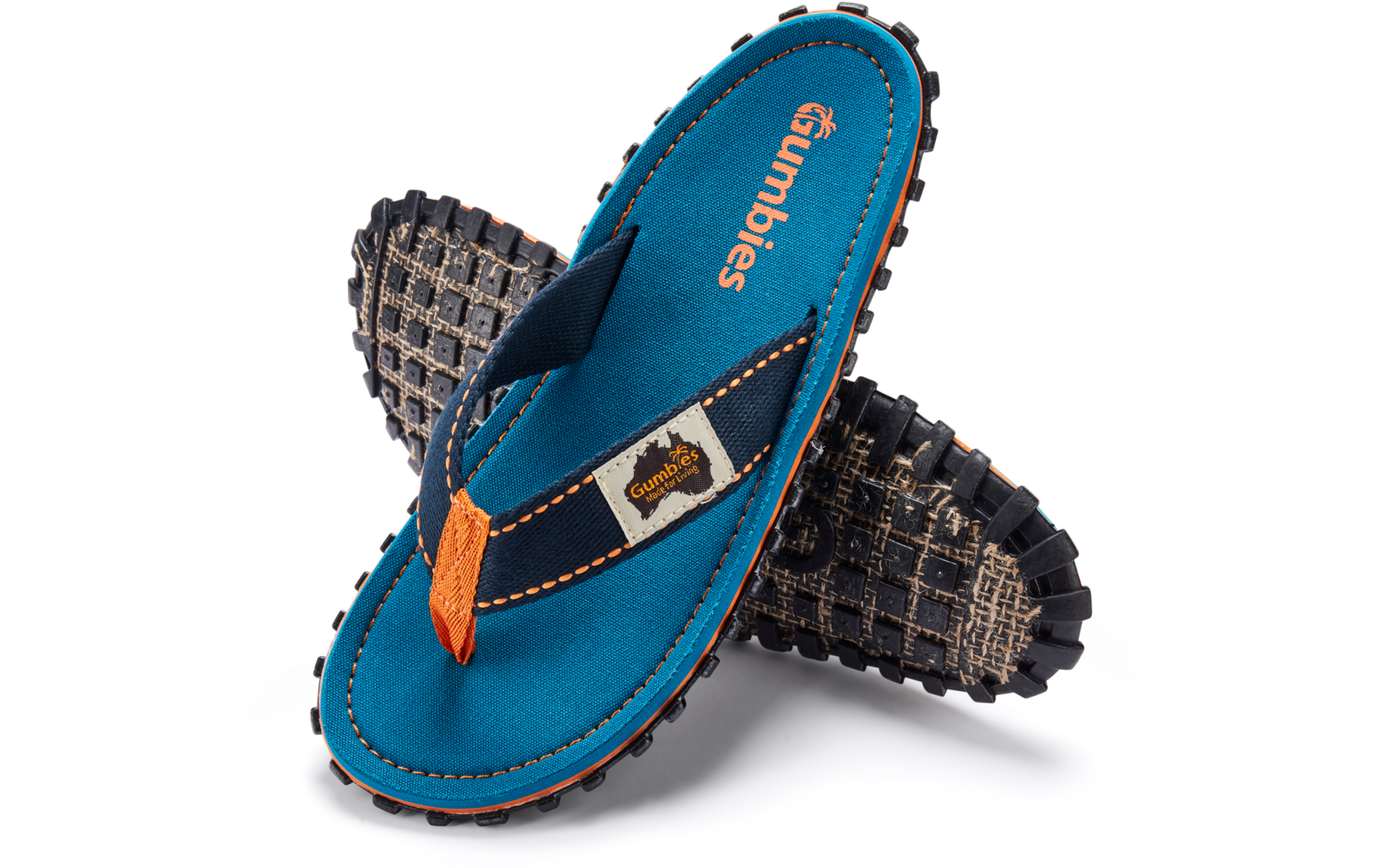 Blue flip-flop sandal with black lug sole, orange stitching and toe post, one sandal crossed over the other on a white background