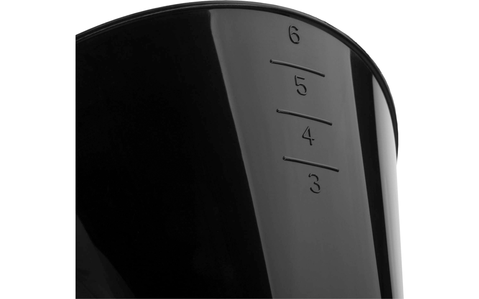 Close-up of a glossy black surface with raised measurement marks and the numbers 3, 4, 5, 6