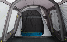 Interior view of a tent with an open entrance and blue floor mat