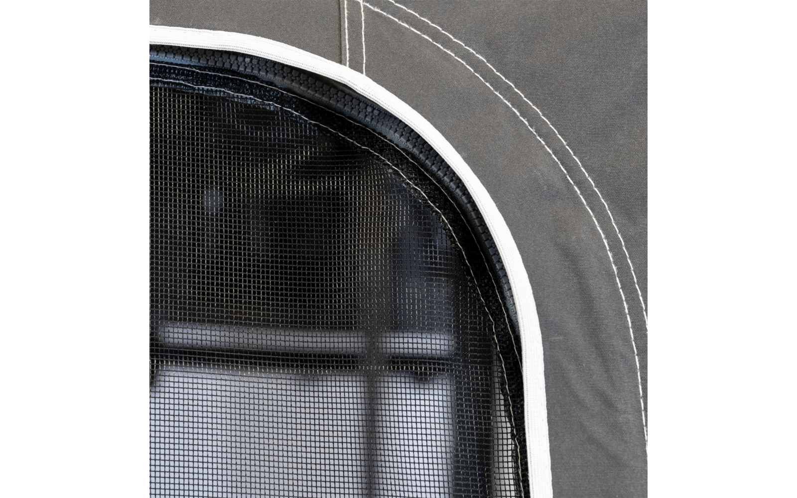Gros plan sur un filet noir avec une bordure blanche et un tissu gris avec des coutures blanches