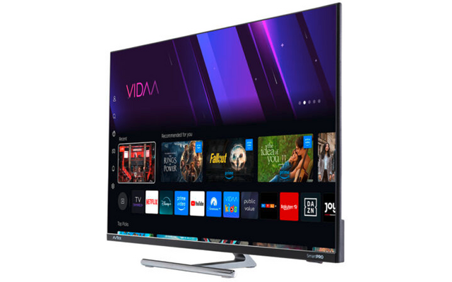 Flachbildfernseher auf Standfuß, seitlich gezeigt; Bildschirm mit lila Verlaufbanner 'VIDAA' oben und Reihen von App-Symbolen darunter (z. B. Netflix, Prime Video, YouTube, Disney+)