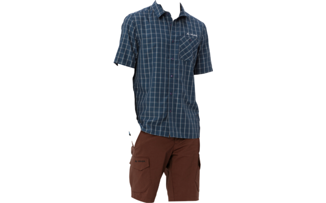 Man wearing a blue checked short-sleeve shirt and brown cargo shorts, with black sneakers and white socks, standing on a white background looking left