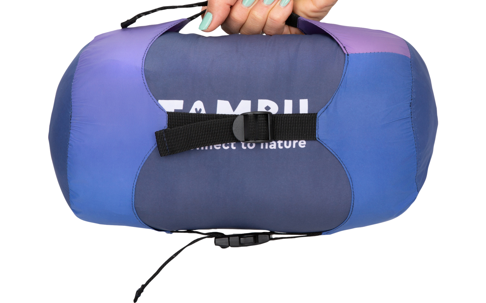 Hand holding a blue-purple compression sack, black carrying strap, partially visible white text 'TAMB'