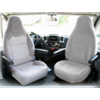 Two gray car seats inside a vehicle with armrests and a view through the front windshield