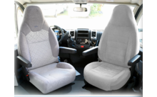 Two gray car seats inside a vehicle with armrests and a view through the front windshield