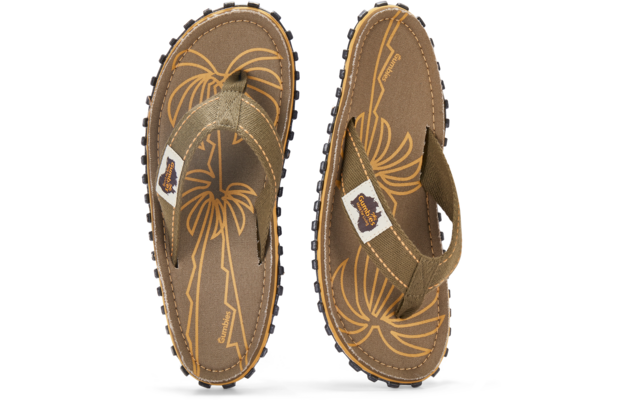 Two brown flip-flop sandals seen from above, yellow palm-tree print, fabric straps with white brand tag, textured rubber soles