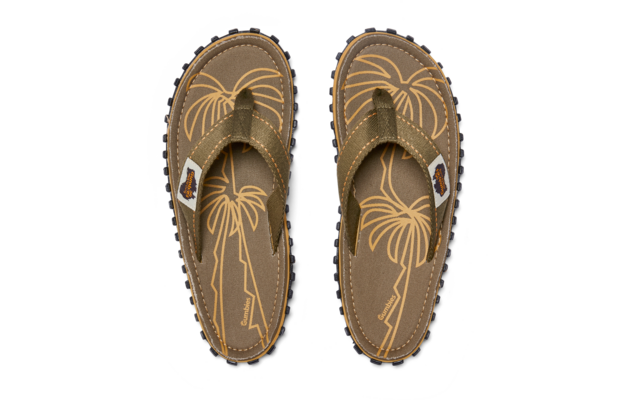 Two olive-green flip-flop sandals side by side, top-down view; footbeds with yellow-beige palm tree print, white label on the straps, black lug soles, yellow decorative stitching