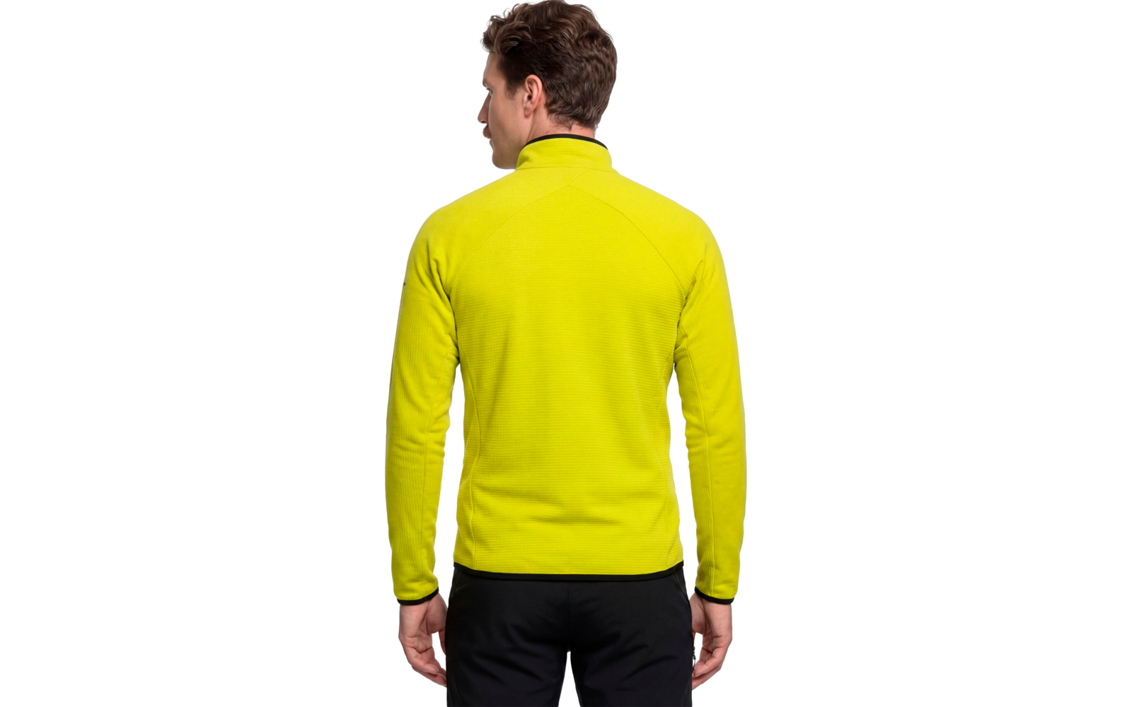 Person von hinten in gelbgrüner Fleecejacke mit hohem Kragen und schwarzer Hose, kurze braune Haare, weißer Hintergrund