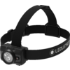 Lampe frontale noire avec lentille LED ronde à l'avant, bandeau élastique marqué "LEDLENSER" et boucles réglables