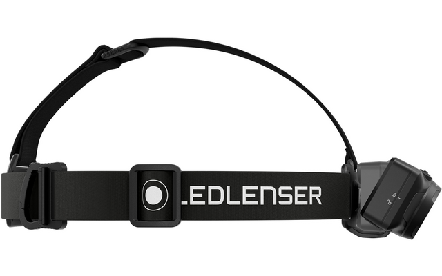 Schwarzes Stirnband mit elastischem Riemen, mittig rechteckiges Kunststoffelement mit rundem weißem Kreis, weiße Aufschrift .EDLENSER auf dem Band, rechts rechteckiges Lampengehäuse mit LED‑Modul