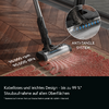 Vacuum cleaner floor head on herringbone wood floor beside a red rug; inset circle shows brush head with hair and blue lights; visible text 'ANTI-TANGLE SYSTEM' and '90.000 rpm 90.000 dPa' and product text bar at bottom