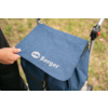 Hand holding the flap of a blue bag with white 'AG Berger' logo attached to a stroller; grass in the background