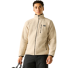 Person mit beige Fleecejacke (Vollreißverschluss, vertikale Brusttasche, seitliche Reißverschlusstaschen), schwarze Hose, hält schwarzen Taschenhenkel, weißer Hintergrund