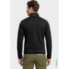 Personne de dos portant une veste noire à col montant et un pantalon vert olive, cheveux bruns courts, fond clair, petit logo triangulaire sur l'épaule droite, couture verte au dos du col, fermeture éclair claire sur la poche arrière droite