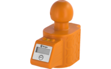 Objeto de plástico naranja con base cúbica y parte superior esférica, pequeña pantalla rectangular con botón 'ON/OFF', pequeña burbuja de nivel, rótulo 'Berger', lados texturizados
