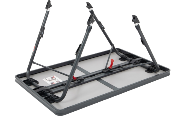 Schwarzer Fahrradträger mit roten Haltepunkten auf einem grauen Untergrund