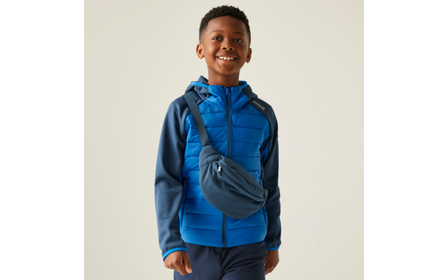 Jongen draagt blauwe hoodie en schoudertas, lacht