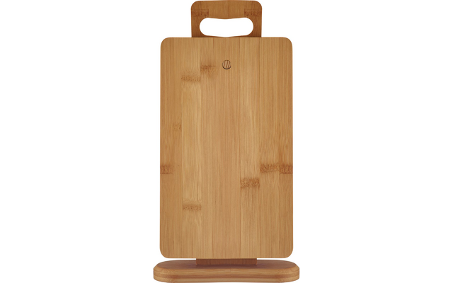 Light bamboo cutting board with rounded corners and handle cutout, standing upright on a matching wooden stand