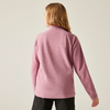 Frau von hinten mit rosa Pullover und schwarzer Hose vor hellem Hintergrund