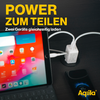 Tablet mit bunter App-Startseite neben zwei weißen Ladegeräten, die an einer Steckdose angeschlossen sind