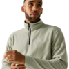 Person, chest-up view, wearing light green fleece with stand collar and half zipper, short hair, short beard, hands near chest, looking up and to the right, white background
