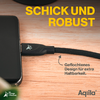 Schwarzes Netzteil auf Holzoberfläche mit Kabel und gelbem Text ‚Schick und robust‘