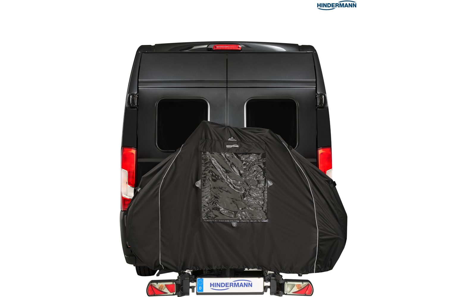 Heckansicht eines schwarzen Vans mit einer schwarzen Abdeckung auf dem Heck-Fahrradträger, mit rechteckigem durchsichtigem Fenster und Kennzeichen "HINDERMANN"