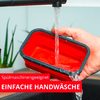 Hand hält roten rechteckigen Behälter unter fließendem Wasser aus einem Wasserhahn über einem Spülbecken; Topfpflanze im Hintergrund; rotes Banner mit weißem Text 'Spülmaschinengeeignet' und 'EINFACHE HANDWÄSCHE'