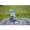 Light blue folding lounge chair with headrest on a gray rug with white pattern on grass