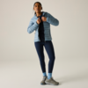 Person steht, trägt hellblaue gesteppte Jacke, dunkles Oberteil, dunkelblaue Leggings, hellblaue Socken und graue Wanderschuhe, Hände am Kragen der Jacke