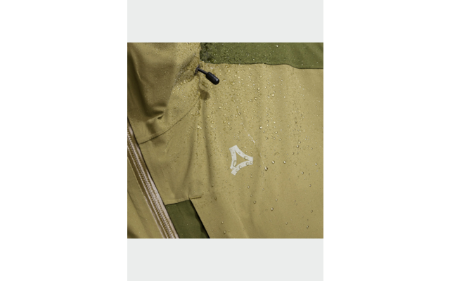 Gros plan d'une veste vert olive avec des gouttes d'eau, fermeture éclair visible, stoppeur de cordon et petit logo blanc triangulaire