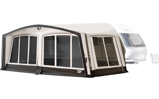 Caravan with attached light-colored awning with large windows