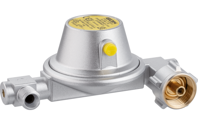 Silbernes rundes Metallgehäuse mit gelbem Aufkleber oben, kleinem gelben Knopf an der Seite und drei Anschlussstücken, eines mit sichtbar messingfarbenem Innengewinde