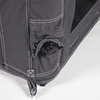 Close-up of a dark gray fabric corner with white stitching, a black plastic round valve and a strap with metal eyelet