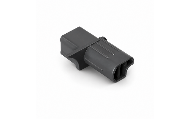Grau-schwarzes Kunststoffteil mit rechteckigem Körper, zwei ovalen Öffnungen an einem Ende, drei erhabenen Längsrippen auf der Oberseite, weißer Hintergrund