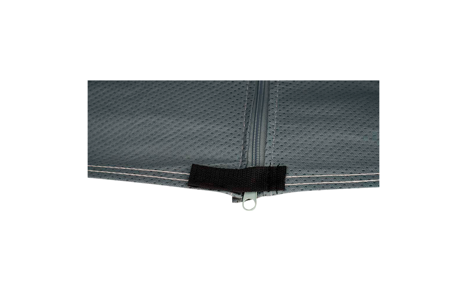 Close-up of a gray textured fabric with a centered zipper and a black Velcro strip at the bottom