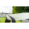 White sunshade stretched over a vehicle roof outdoors