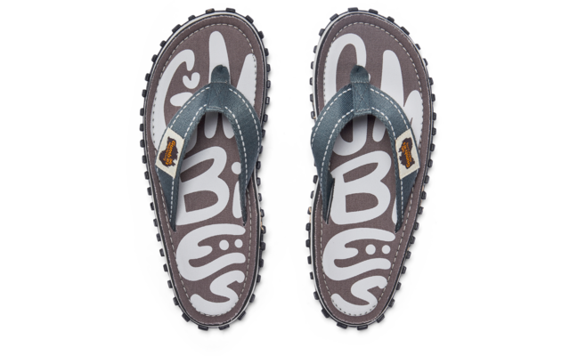 Top view of a pair of flip-flops with gray footbeds and white pattern, blue straps with white stitching and small brown logo patches